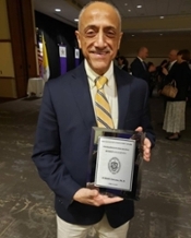 Dr. Zanzana holding his award