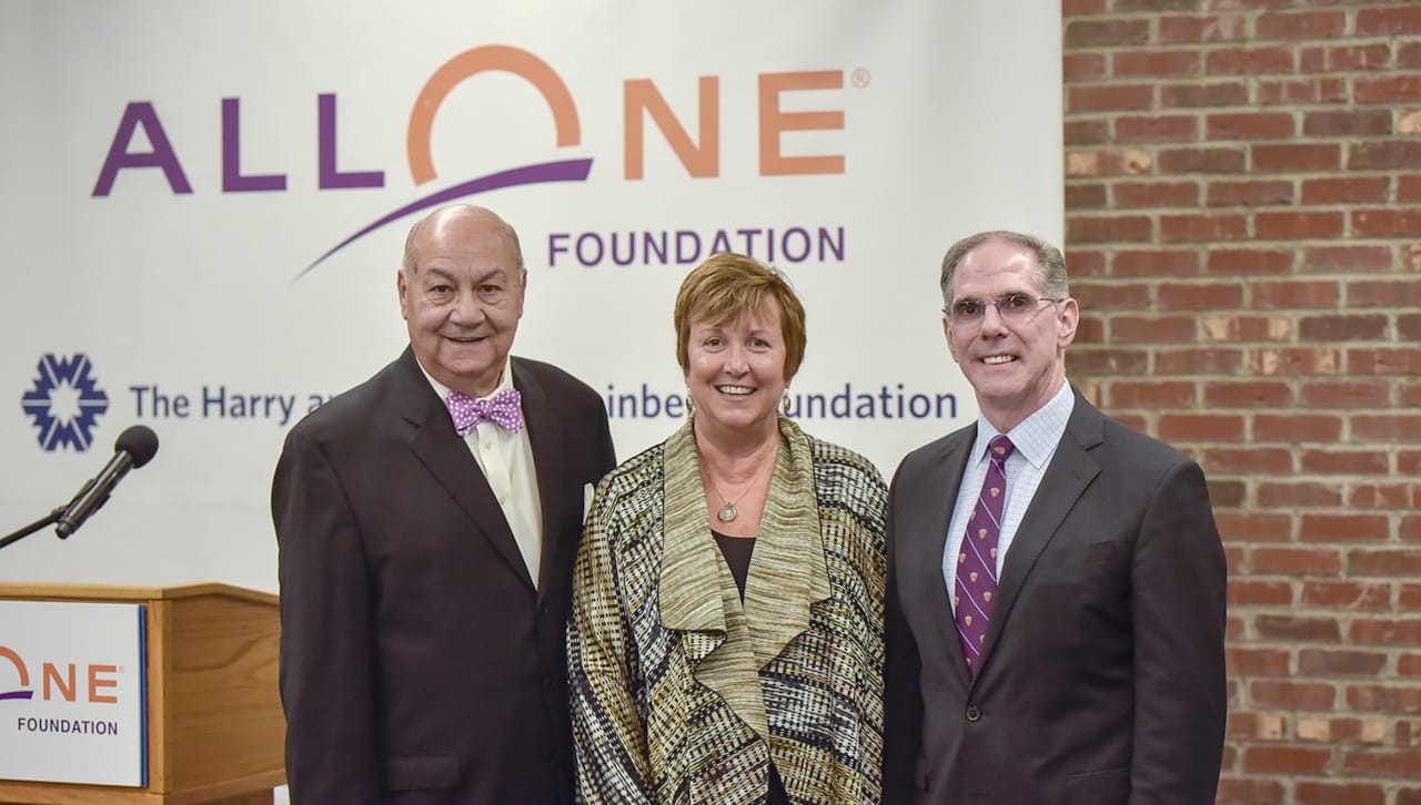 John Moses, Esq., Debra Pellegrino, Ed.D., and John Cosgrove pose for a photo at an AllOne Foundation event.