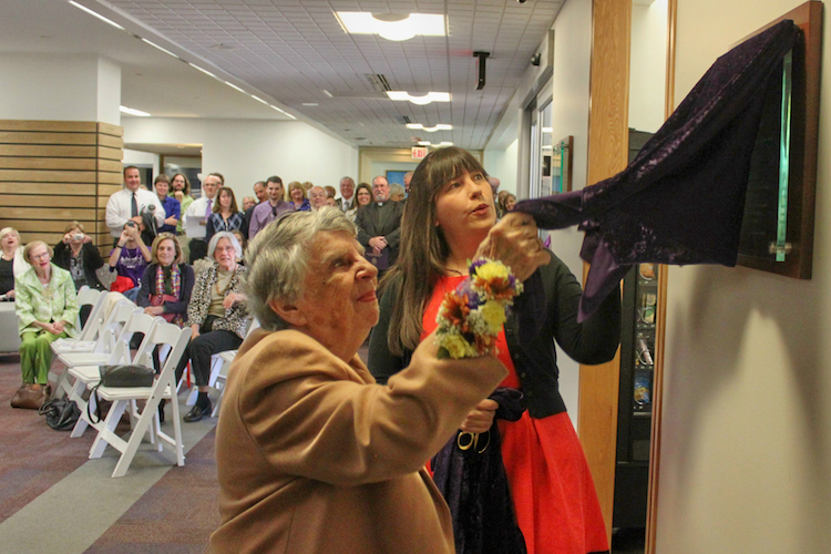 Katherine “Kay” Reilly ’53 unveils a plaque at the Ribbon Cutting Ceremony celebrating the official opening of the Reilly Learning Commons, a redesigned area on the first floor of the Weinberg Memorial Library that was named in honor of Kay, Joe and Evelyn Reilly ’52.