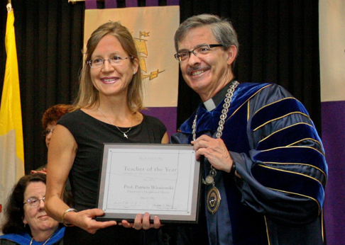 From left: Patricia Wisniewski, faculty specialist for occupational therapy, receives The University of Scranton’s class of 2016 Teacher of the Year award from University President Kevin P. Quinn, S.J.