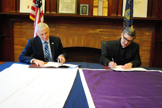 From left: Mark Volk, president of Lackawanna College, and Kevin P. Quinn, S.J., president of The University of Scranton, sign a Memorandum of Understanding to facilitate the transfer of Lackawanna College graduates to the University to complete their bachelor’s degree.