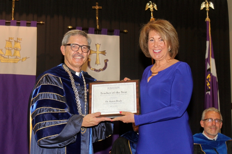 University of Scranton President Kevin P. Quinn, S.J., presents Scranton’s class of 2017 Teacher of the Year award to Karen Brady, D.Ed., assistant professor for occupational therapy.