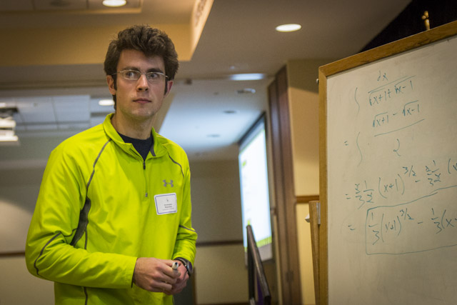 A male student finished solving a problem on the whiteboard during 2012 Integration Bee