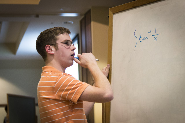 A student solving a problem on the whiteboard during 2012 Integration Bee
