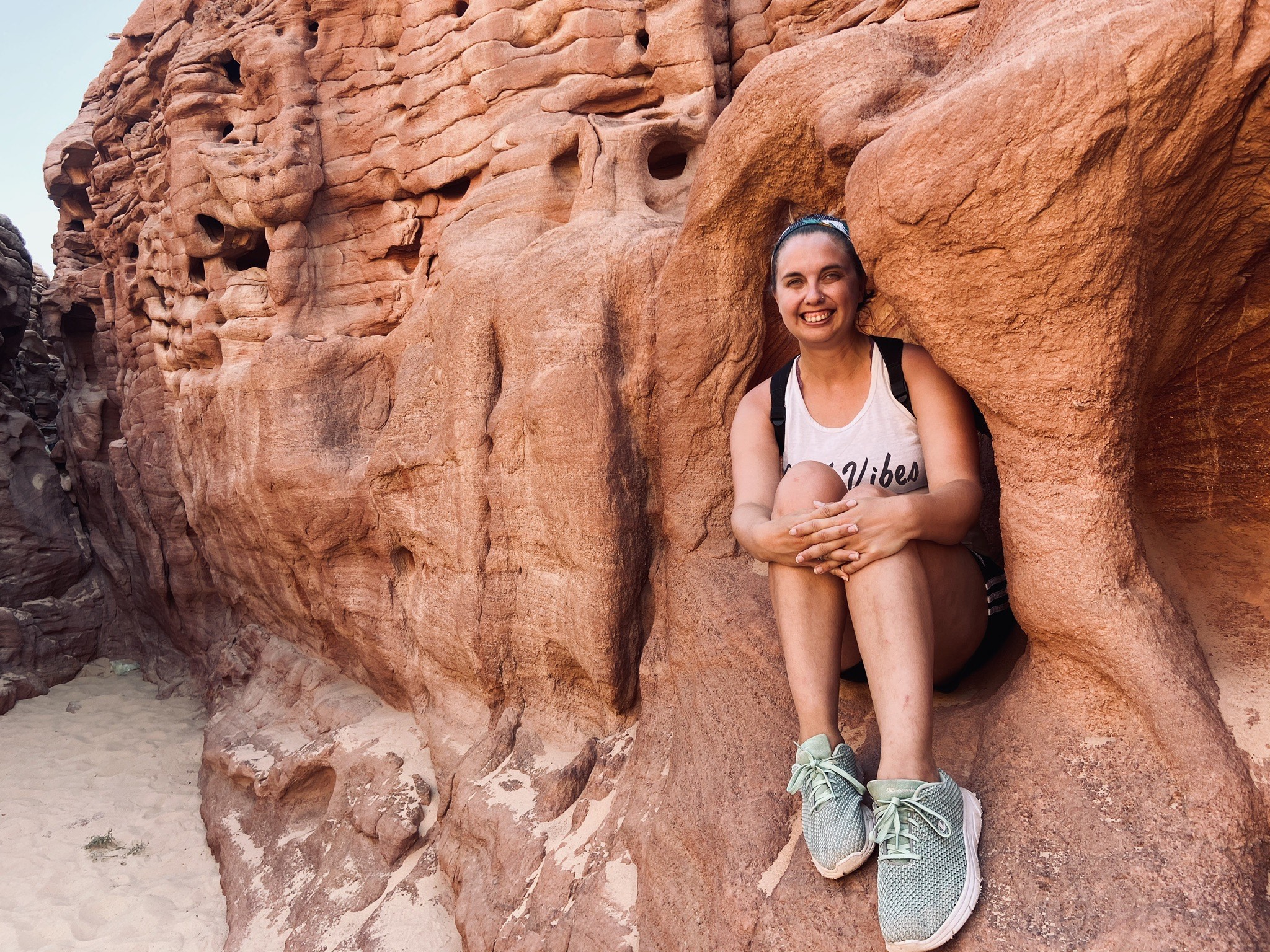 Elena Habersky sitting in between rock formations.