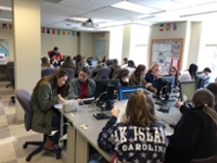 Students gathered at tables for Immersion Day