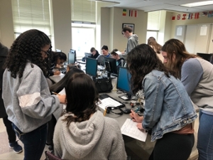 Students gathered in circle at desk