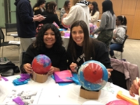 Two smiling students at table