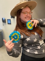 Student wearing a Gaucho hat and holding Argentinian rosette