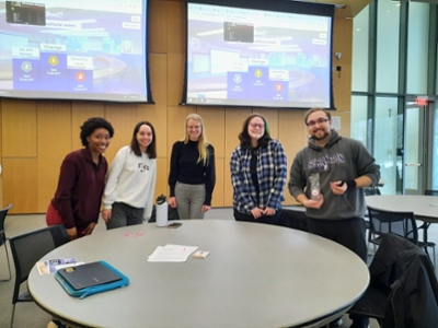 Students standing behind table after playing Kahoot