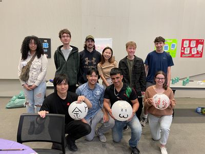 Taiwanese Visiting Instructor, Lily, in center of group of students holding paper lanterns