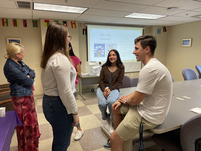 Several students and TAs talking in the Language Learning Center.