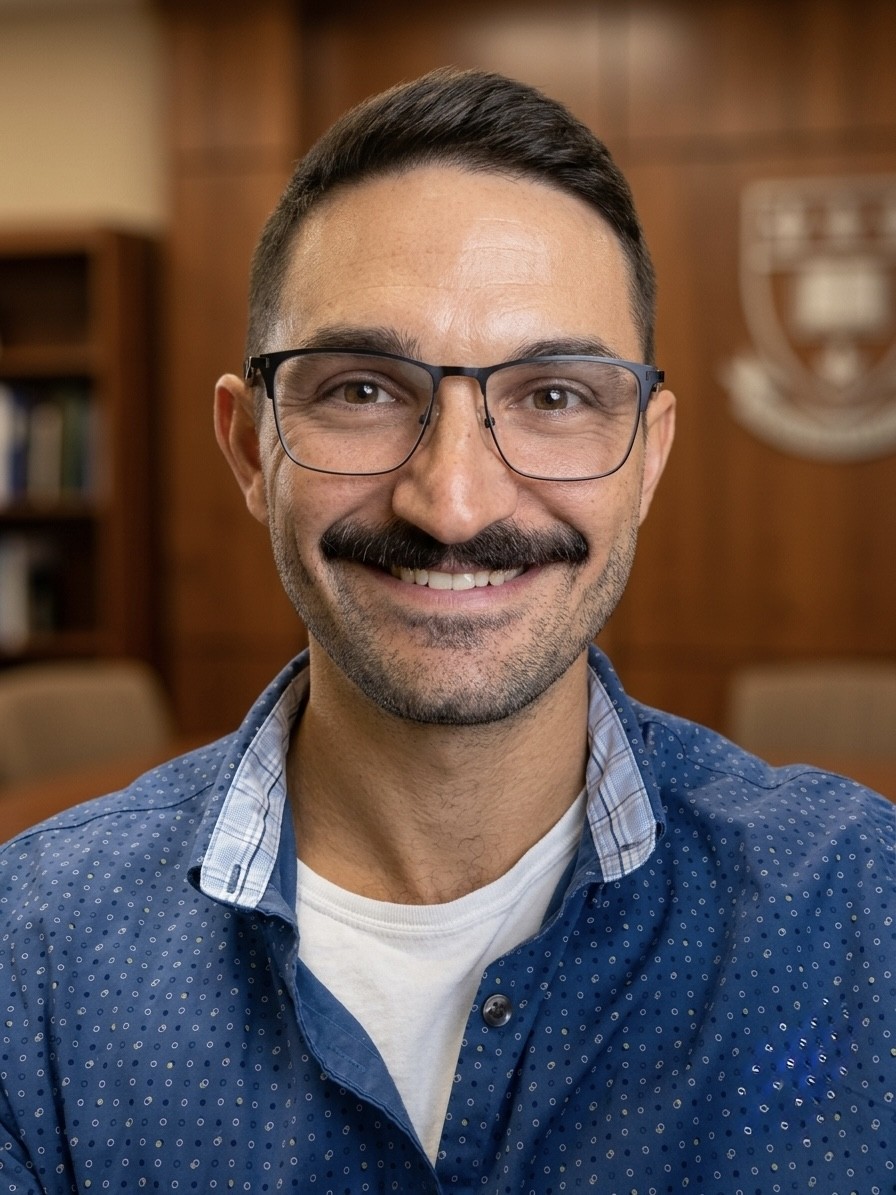 Headshot of man at desk