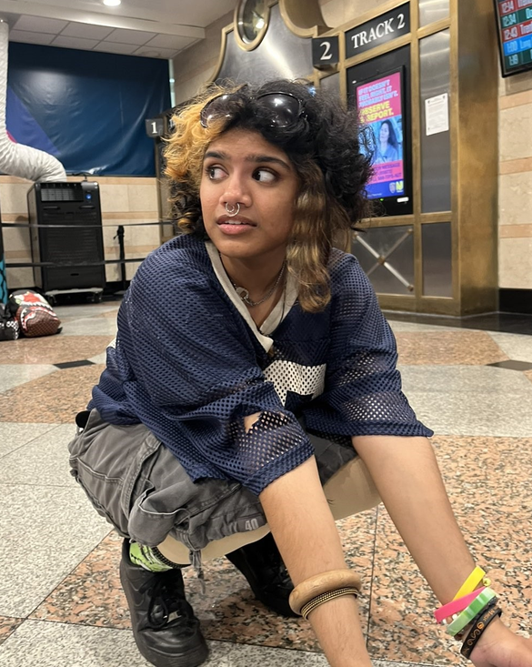 A young woman kneeling inside a building