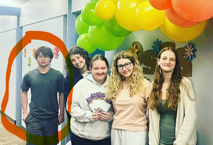 A group of writing tutors with the young man at the left circled