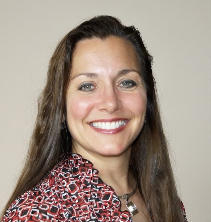 dark haired woman in a bright colored shirt
