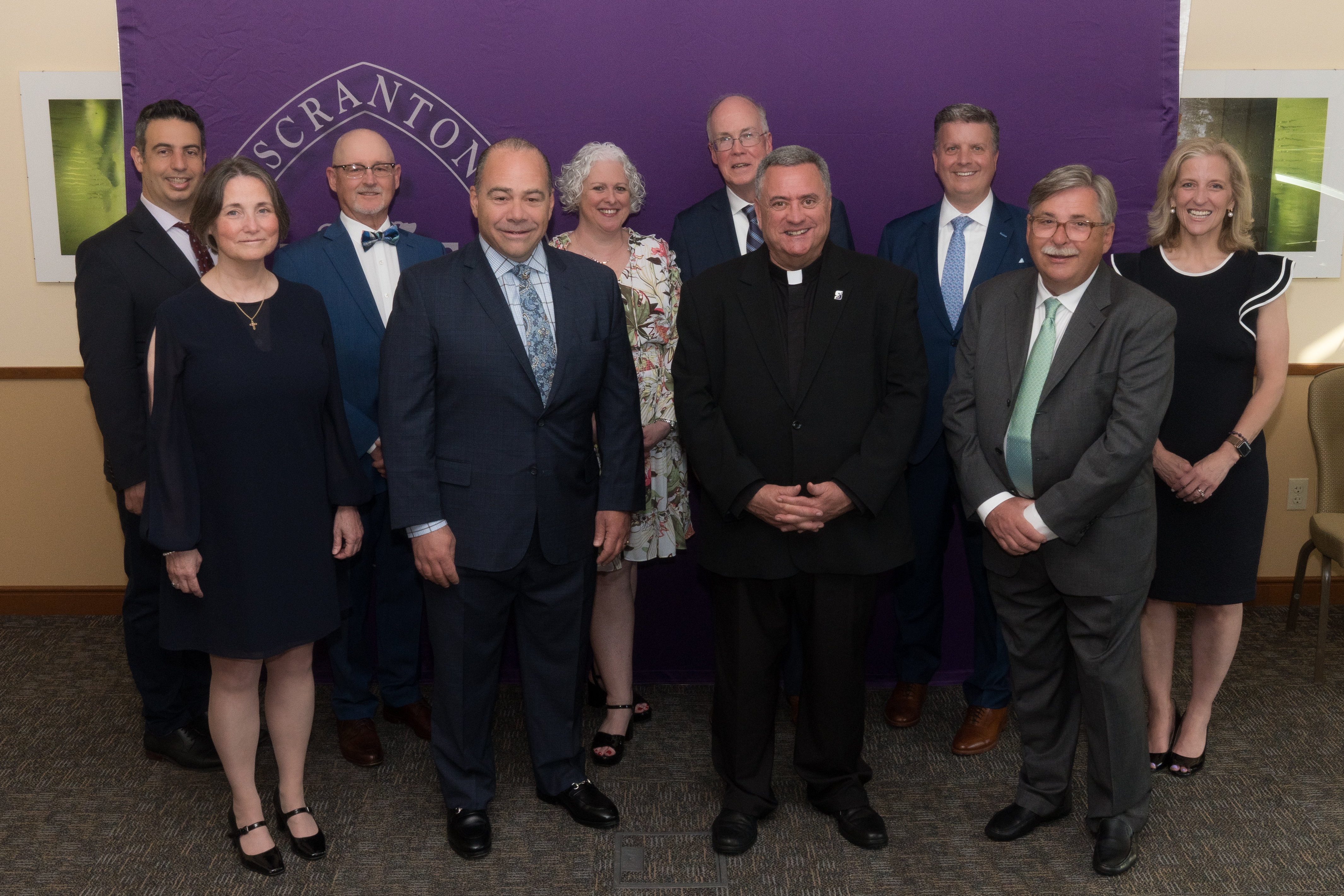 From left, Matthew L. Davidson, Ph.D. '93, P'24, Noradeen Farlekas, LP.D., CFA '83, John J. (Jack) Lynch III '83, Colleen A. Joseph, M.D. '83, Rev. Joseph G. Marina, S.J., University President, Linda Mathias Hee, Esq. '93, Yohuru R. Williams, Ph.D. '93, G'93, Col. Christopher L. Paris, Esq. '98, Erin Tracy Bradley, M.D., MPH '88, and Paul DiPietrantonio '97, 