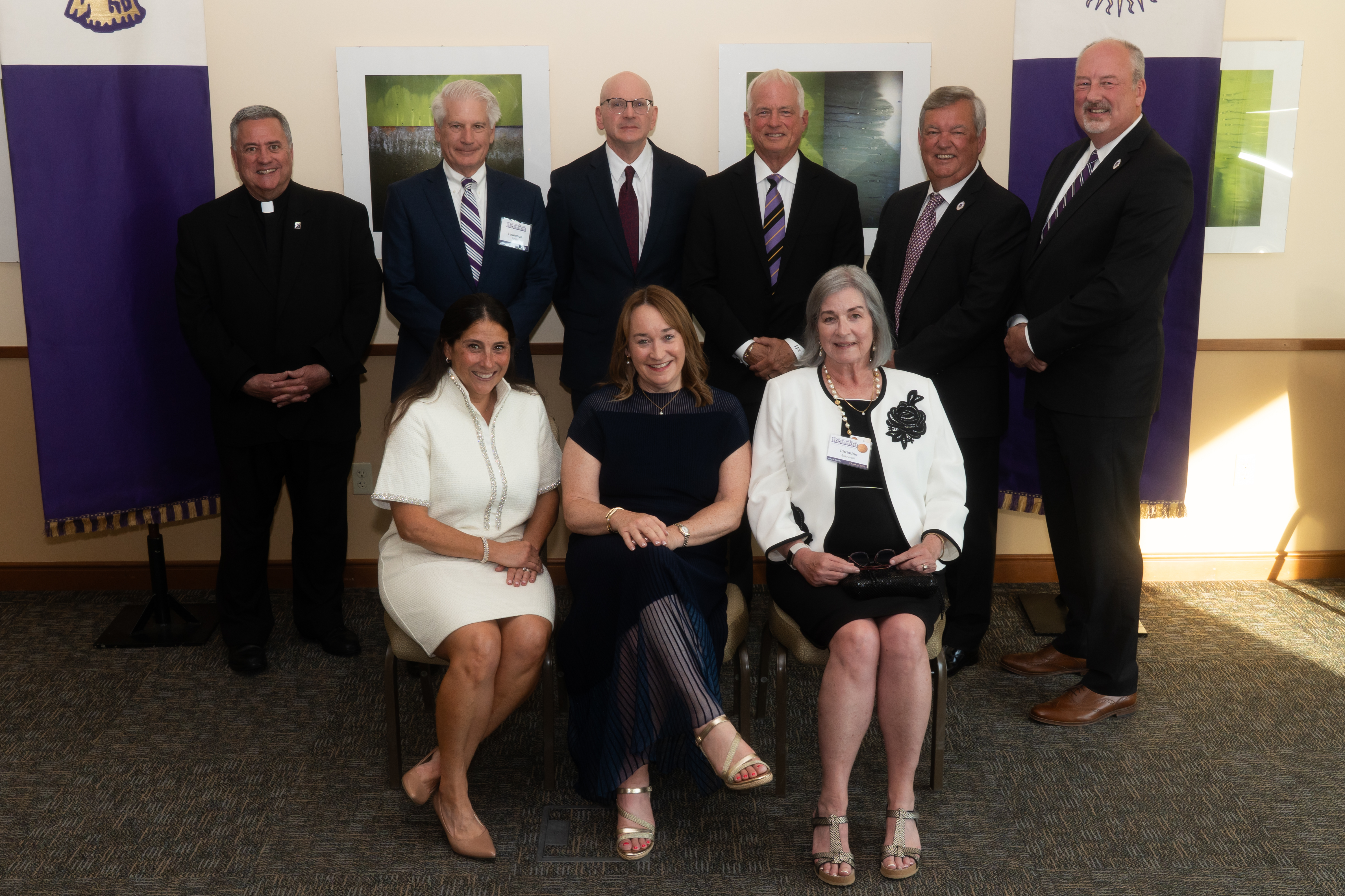 Clockwise from left: Rev. Joseph G. Marina, S.J., University president, Lawrence R. Lynch, CPA '81, H'22, James M. Slattery '86, H'23, Dcn. James J. Knipper '81, Justin B. Murphy '76, Alumni Society Chair Chris Neumann, Esq. '87, Christine Blazynski, Ph. D. '76, Patti A. Clarke '86, P'17, '19, and Elizabeth Madden '96 enjoy a moment together at the 2026 O'Hara Awards Ceremony. Thomas J. Gibbons '96, G'99 was honored in memoriam.