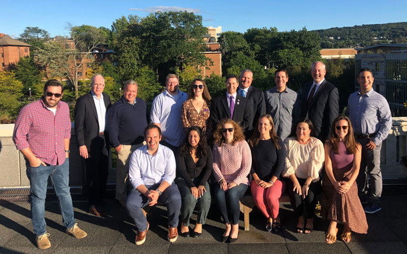 16 Members of the Alumni Society Advisory Board pose for a photo on the roof of the Weinberg Memorial Library.