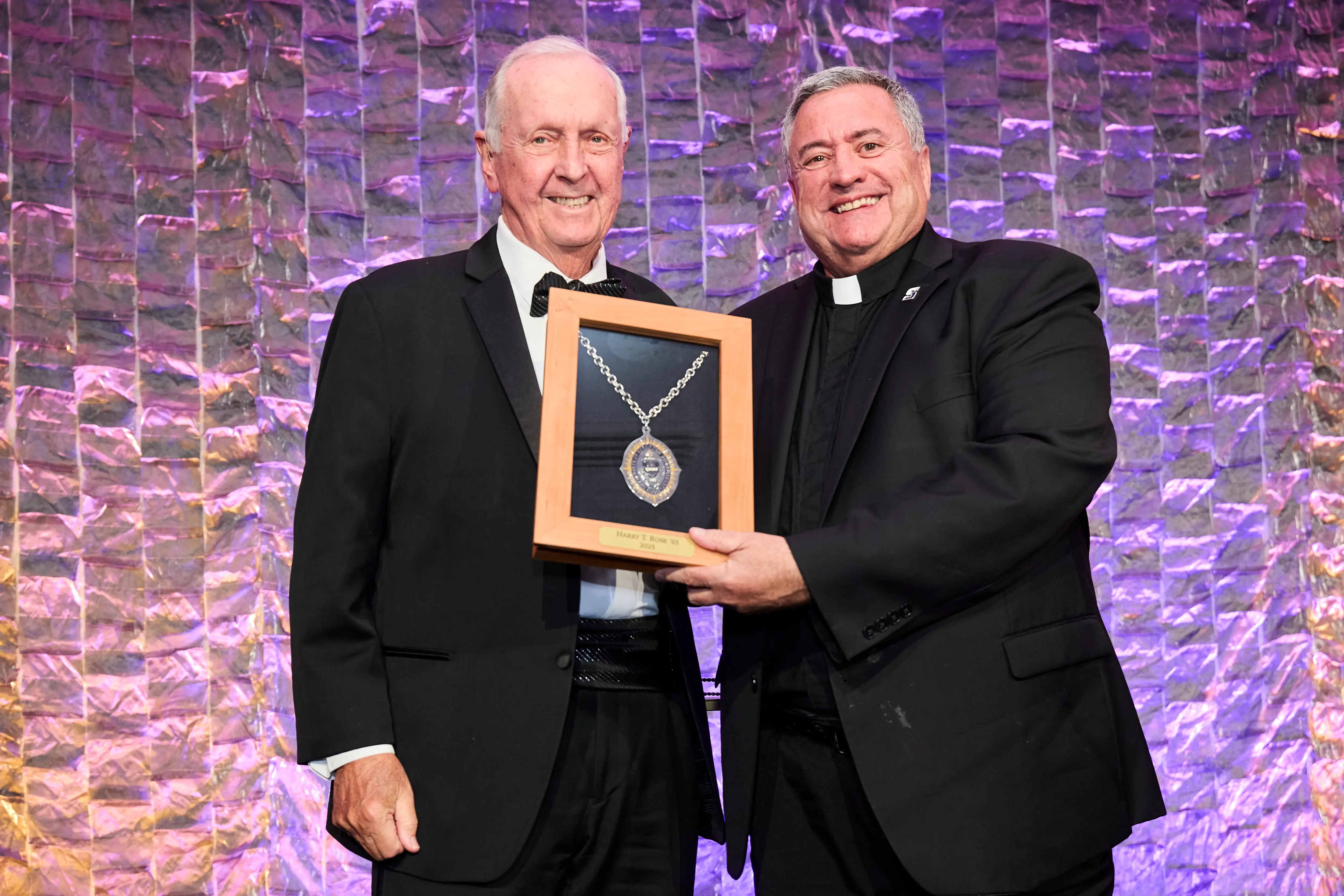 Harry Rose receives the President's Medal from Father Marina