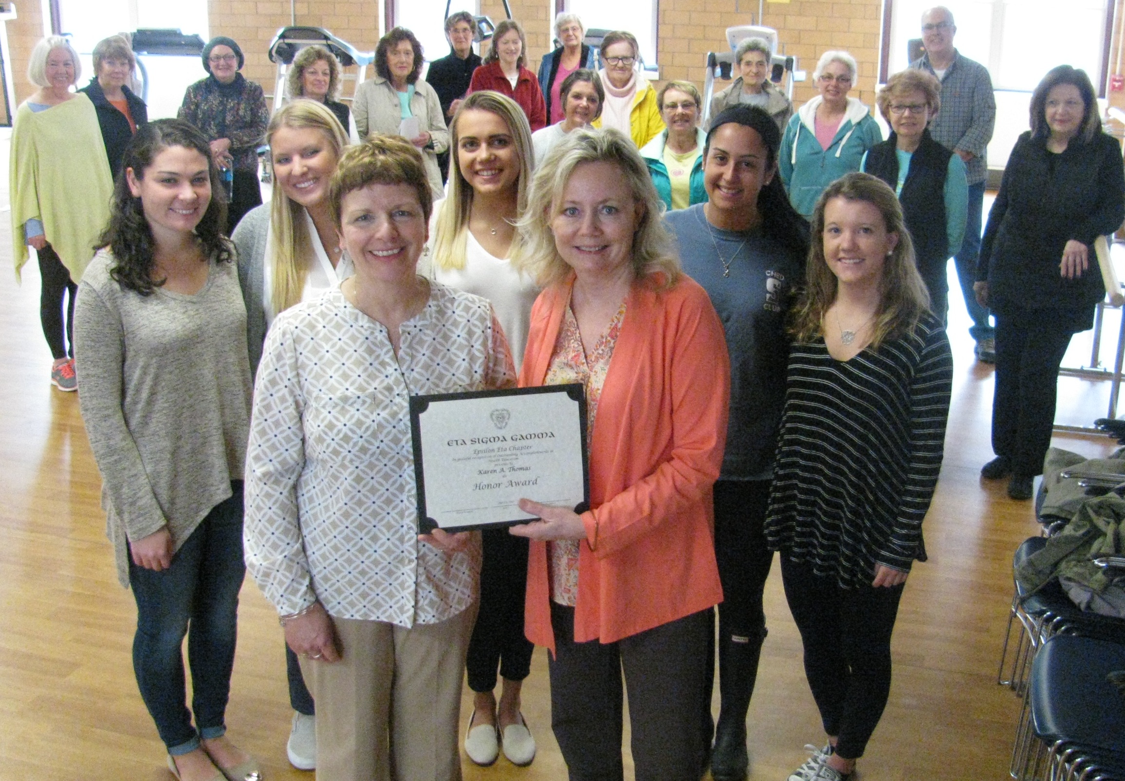 The University of Scranton’s Community Health Education Honor Society, Eta Sigma Gamma, presented health educator Karen A. Thomas with the Outstanding Accomplishments in Health Education Award at the West Side Active Older Adult Community Center in April. The award is given to individuals or organizations that have made major contributions to the health education profession through service, education and/or research. The University has partnered with Thomas since 2007 to support the community center’s Growing Stronger Program as a community-based learning project. First row, from left, Thomas, Lackawanna County’s Penn State Extension, and Debra L. Fetherman, Ph.D., the University’s community health education program director and the honor society’s faculty advisor. Second row: University community health education majors Mary Cash, Bayside, New York; Amanda Peters, Amawalk, New York: Olivia Lada, Wayne, New Jersey; Marisa Ciriello, Hicksville, New York; and Maribeth Keith, King of Prussia.