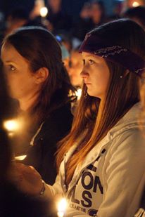 Student holding candle for candlelight vigil at TBTN